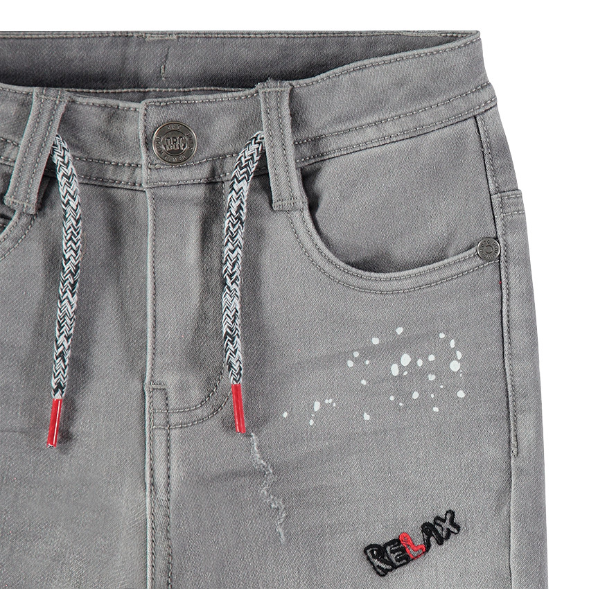 Τζιν με used όψη, τυπωμένες κηλίδες χρώματος και απλικέ σήματα 